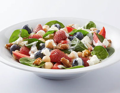 Chickpea and berry salad from Kroger in white bowl on white table