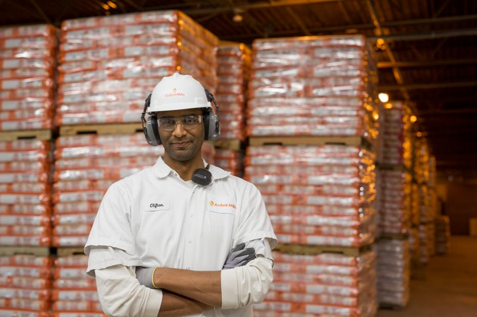 Man in safety gear standing in a warehouse